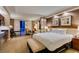 Spacious hotel suite bedroom with a king bed, dining area, and a balcony with city views at 125 E Harmon Ave # 717, Las Vegas, NV 89109