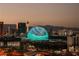 The Las Vegas skyline glows with the MSG Sphere illuminated in green and white hues at dusk at 125 E Harmon Ave # 717, Las Vegas, NV 89109
