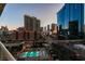 Enjoy city views from this condo's balcony showcasing the expansive skyline and pool at 125 E Harmon Ave # 717, Las Vegas, NV 89109