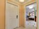 Suite entryway with a white door, textured walls, and a glimpse of the bedroom at 125 E Harmon Ave # 717, Las Vegas, NV 89109