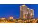 Modern luxury high-rise condominiums with lighted spires overlooking the city skyline at dusk at 125 E Harmon Ave # 717, Las Vegas, NV 89109