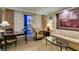 Comfortable living room area features a plush sofa, armchair, table, and large windows with city views at 125 E Harmon Ave # 717, Las Vegas, NV 89109