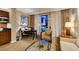 Open living area featuring a kitchenette, dining table, comfortable seating, and city views at 125 E Harmon Ave # 717, Las Vegas, NV 89109