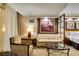 Comfortable seating area with a soft sofa and cozy chair, complemented by a decorative piece of artwork at 125 E Harmon Ave # 717, Las Vegas, NV 89109