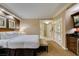 Bright primary bedroom showcasing white bedding, wood cabinets and kitchenette with stainless steel appliances at 125 E Harmon Ave # 717, Las Vegas, NV 89109