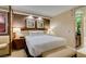 Bright primary bedroom offering a king bed, nightstands, and ensuite bath with stone vanity at 125 E Harmon Ave # 717, Las Vegas, NV 89109