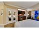 Hotel suite featuring an open bedroom area, a full wet bar, and mirrored closet doors at 125 E Harmon Ave # 717, Las Vegas, NV 89109