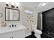 Stylish bathroom showcasing a black tiled shower, modern fixtures, and a bright, clean aesthetic at 1320 Wengert Ave, Las Vegas, NV 89104
