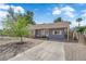 Charming single story home with gray exterior, brick detail, drought landscaping, and mature tree at 1320 Wengert Ave, Las Vegas, NV 89104