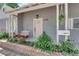 Welcoming front porch with swing seat, hanging plants, brick detail, and pale pink front door at 1320 Wengert Ave, Las Vegas, NV 89104