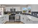 Updated kitchen with white cabinets, stainless steel appliances, and a view from the window at 1320 Wengert Ave, Las Vegas, NV 89104