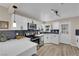 Modern kitchen features white cabinets, sleek appliances, and a stylish backsplash at 1320 Wengert Ave, Las Vegas, NV 89104