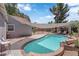 A curved swimming pool area provides backyard fun under a shade, with a nice deck area at 1320 Wengert Ave, Las Vegas, NV 89104