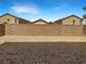 A backyard features a low brick wall and gravel ground at 148 Campbelltown Ave, Henderson, NV 89015