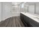 Bathroom featuring double vanity sinks, modern fixtures, and a bathtub with sliding glass doors at 148 Campbelltown Ave, Henderson, NV 89015