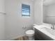 Modern bathroom features a vanity and toilet, with a window for natural light at 148 Campbelltown Ave, Henderson, NV 89015
