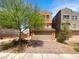 Two-story house featuring an attached garage, brick driveway, and landscaped front yard at 148 Campbelltown Ave, Henderson, NV 89015