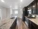 Modern kitchen with stainless steel appliances, granite countertops, and dark wood cabinets at 148 Campbelltown Ave, Henderson, NV 89015