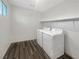 Bright laundry room with a side-by-side washer and dryer set and a shelf at 148 Campbelltown Ave, Henderson, NV 89015