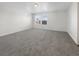 Bright, open living room with plush gray carpeting and multiple windows at 148 Campbelltown Ave, Henderson, NV 89015