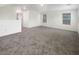 Spacious living room featuring gray carpet and plentiful natural light from several windows at 148 Campbelltown Ave, Henderson, NV 89015