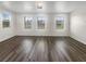 Sunny living area with sleek wood floors and ample natural light from many windows at 148 Campbelltown Ave, Henderson, NV 89015