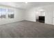 Open living room with neutral carpet, white walls, and access to the kitchen and other areas at 148 Campbelltown Ave, Henderson, NV 89015