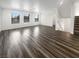 Spacious room showcasing wood floors, bright white walls, and a staircase to the second floor at 148 Campbelltown Ave, Henderson, NV 89015