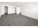 A bright bedroom features an open closet space, white walls, and carpeted flooring at 148 Campbelltown Ave, Henderson, NV 89015