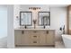 Stylish bathroom with dual sinks, modern fixtures, and a luxurious soaking tub at 1553 Ravanusa Dr, Henderson, NV 89052