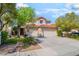 Charming two-story home with attached two-car garage and well manicured landscaping at 1553 Ravanusa Dr, Henderson, NV 89052