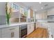 Bright kitchen featuring stainless steel appliances, white marble counters, and sleek cabinetry at 1553 Ravanusa Dr, Henderson, NV 89052
