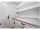 Pantry featuring built-in shelves, cabinets, and a sleek countertop at 1553 Ravanusa Dr, Henderson, NV 89052