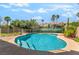 Sparkling pool with clear blue water, surrounded by lush landscaping at 1553 Ravanusa Dr, Henderson, NV 89052