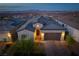 Night aerial view of a beautiful home with its warm and inviting lighting at 174 Cabo Cruces Dr, Henderson, NV 89011
