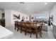 Open floor plan dining room with a large wooden table and chairs at 174 Cabo Cruces Dr, Henderson, NV 89011