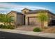 Charming single-story home with a well-maintained front yard, a brick driveway, and an attached two-car garage at 174 Cabo Cruces Dr, Henderson, NV 89011
