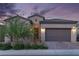 Charming home showcasing a well-maintained yard, desert landscaping, and inviting front entrance at 174 Cabo Cruces Dr, Henderson, NV 89011