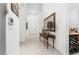 Bright hallway with a decorative table, a mirror, and access to the front door at 174 Cabo Cruces Dr, Henderson, NV 89011