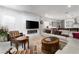 Spacious living room with modern fireplace, comfortable seating, and a view into the kitchen at 174 Cabo Cruces Dr, Henderson, NV 89011