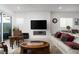 Inviting living room with fireplace, comfortable sofa, and access to an outdoor patio at 174 Cabo Cruces Dr, Henderson, NV 89011