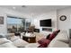 Cozy living room featuring a modern fireplace, comfortable seating, and scenic outdoor views at 174 Cabo Cruces Dr, Henderson, NV 89011