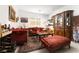 Elegant living room featuring plush seating, ornate cabinet, and stylish decor with a rich color palette at 174 Cabo Cruces Dr, Henderson, NV 89011
