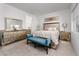 Bright and modern main bedroom featuring a large mirror dresser, upholstered headboard and bench at 174 Cabo Cruces Dr, Henderson, NV 89011