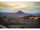 Relaxing views of the nearby mountains and desert landscaping with palm trees at 174 Cabo Cruces Dr, Henderson, NV 89011