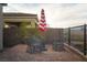Cozy outdoor seating area on a brick patio with a red and white umbrella, great for casual gatherings at 174 Cabo Cruces Dr, Henderson, NV 89011