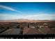 Expansive view of rooftops, mountains, and clear sky, showcasing the beautiful scenery from the property at 174 Cabo Cruces Dr, Henderson, NV 89011