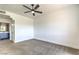 Spacious bedroom with ceiling fan, gray carpeting, and ensuite bath access at 2110 Los Feliz St # 1003, Las Vegas, NV 89156