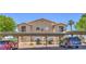 Apartment building featuring covered parking, tidy landscaping, and clearly marked unit numbers at 2110 Los Feliz St # 1003, Las Vegas, NV 89156