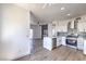 Modern kitchen featuring stainless steel appliances, quartz countertops, and wood-look flooring at 2110 Los Feliz St # 1003, Las Vegas, NV 89156